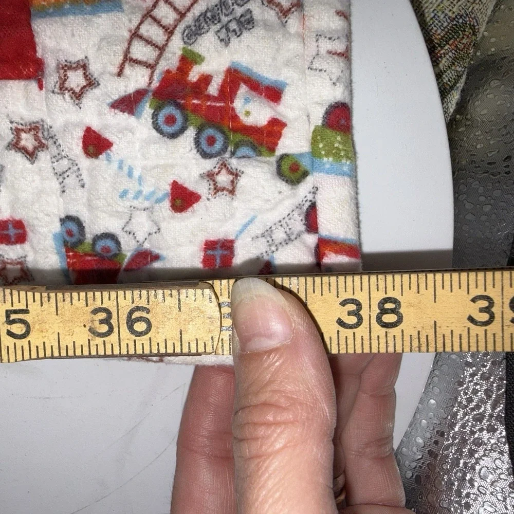 Vtg Baby Quilt Of Trains Print bordered by blue sashing and red cornerstones